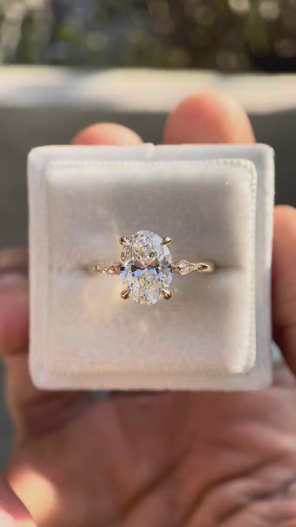 Oval lab diamond trilogy ring with kite side stones video