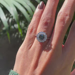 Blue green Old European cut moissanite cluster ring rotating in 10K white gold