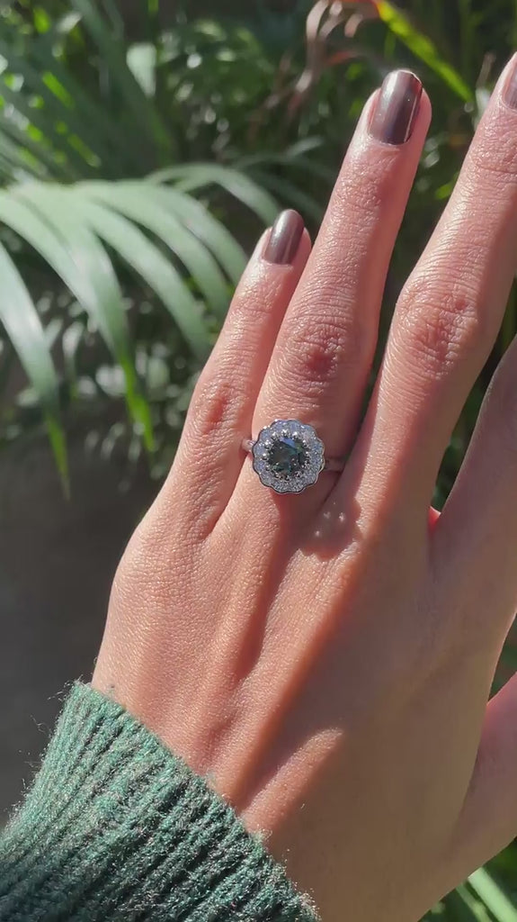 Blue green Old European cut moissanite cluster ring rotating in 10K white gold