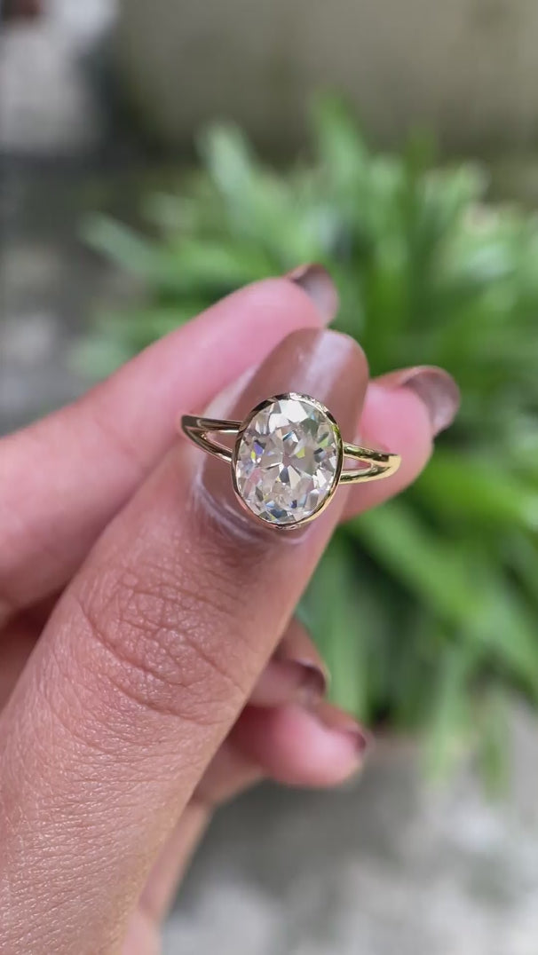 Oval Old Mine Cut moissanite bezel cathedral solitaire ring rotating view