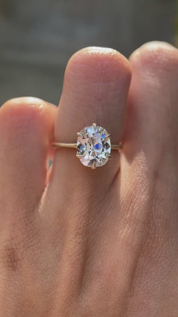 Elongated cushion solitaire engagement ring on hand view video