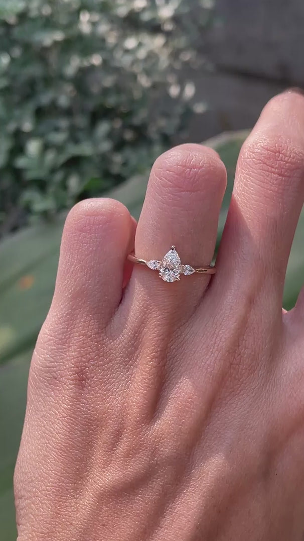 Dainty pear shaped lab diamond three stone ring on hand video