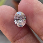 Oval brilliant cut moissanite loose stone displaying sparkle and light performance in motion