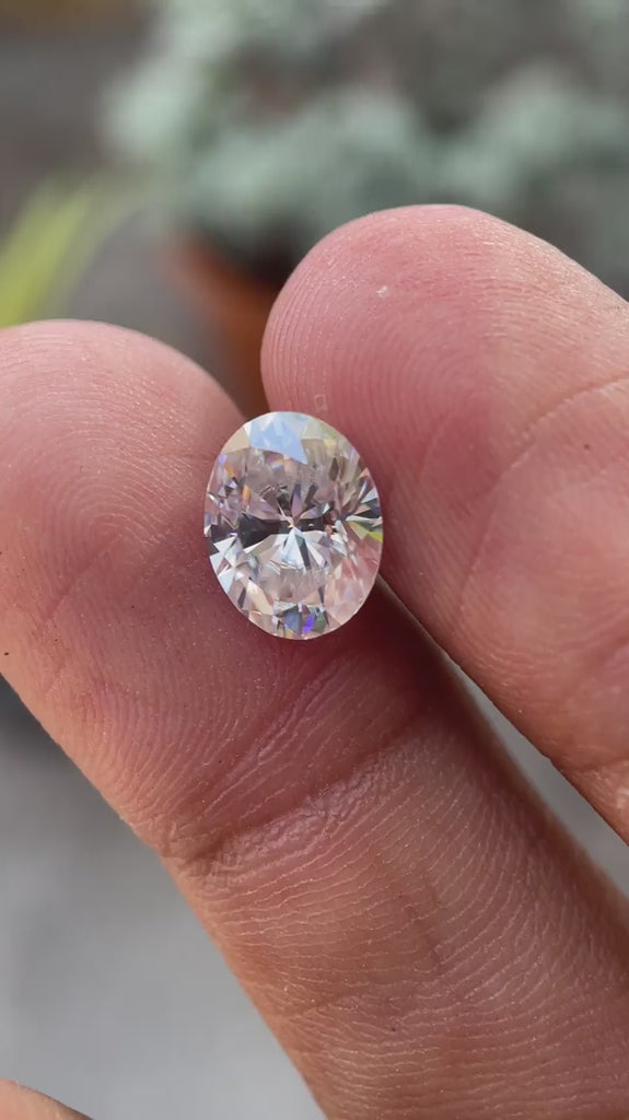 Oval brilliant cut moissanite loose stone displaying sparkle and light performance in motion