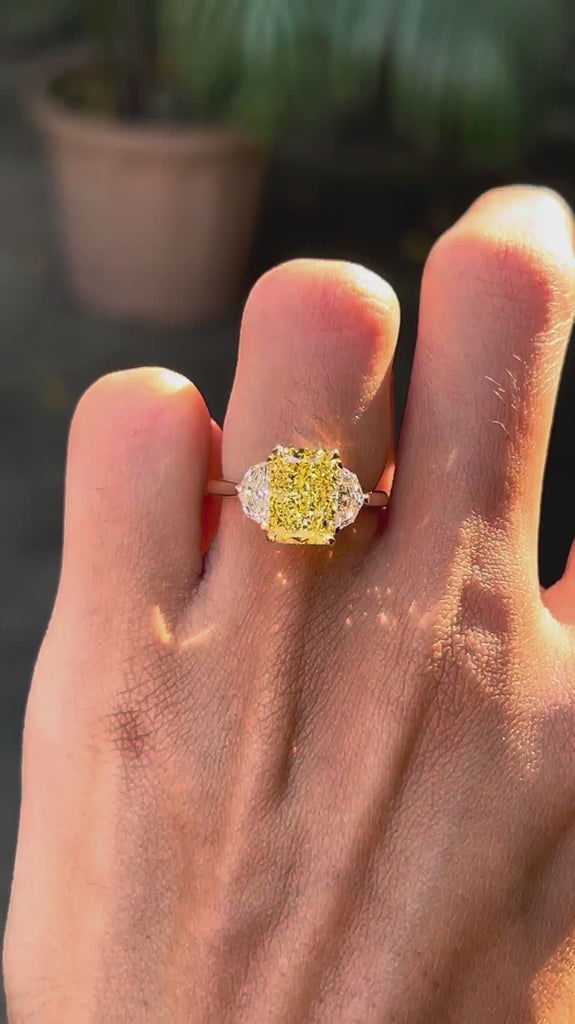 Radiant cut yellow lab diamond three stone engagement ring rotating video view