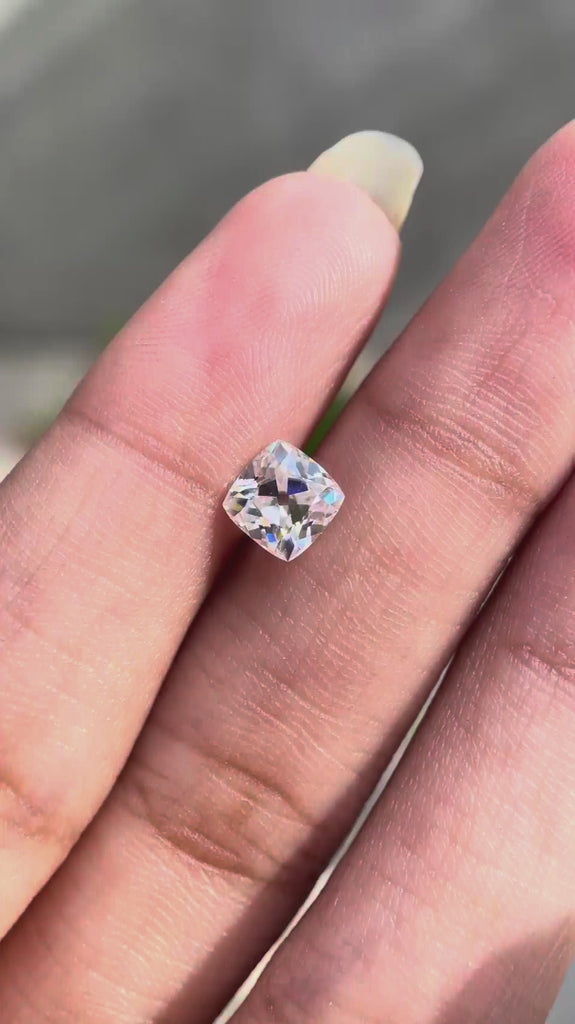 Cushion Peruzzi cut moissanite rotating to show brilliance and faceting