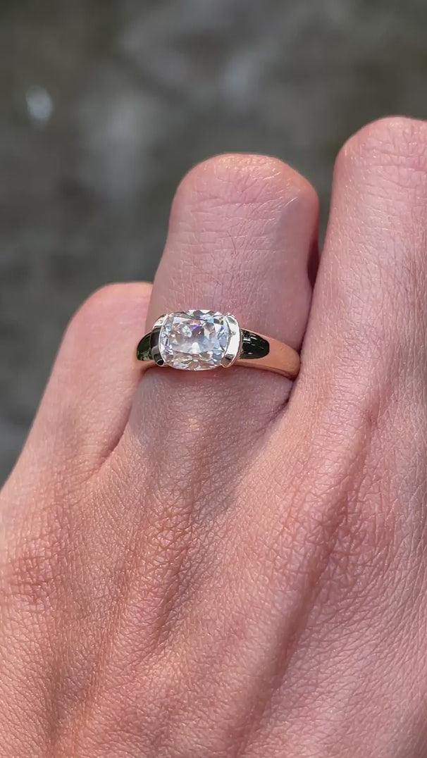 Modern half bezel moissanite engagement ring with bold chunky gold band