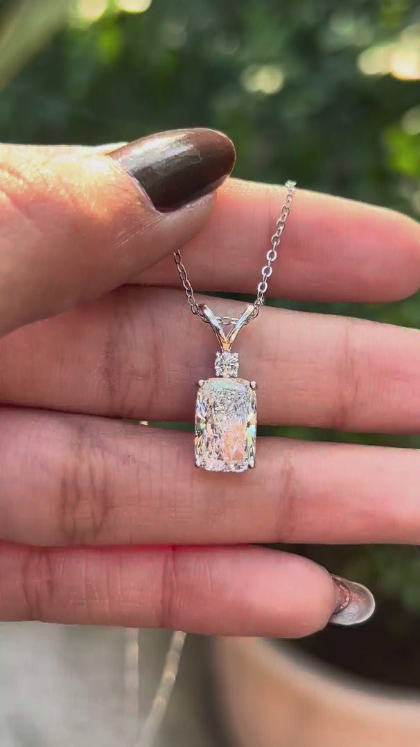 Close rotating view showing cushion diamond pendant with split V bail.