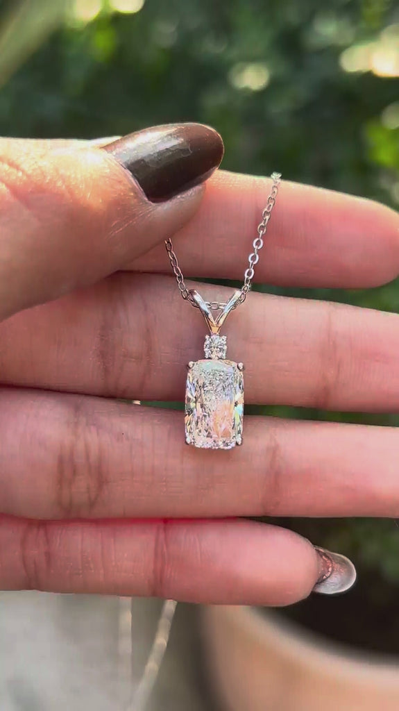 Close rotating view showing cushion diamond pendant with split V bail.