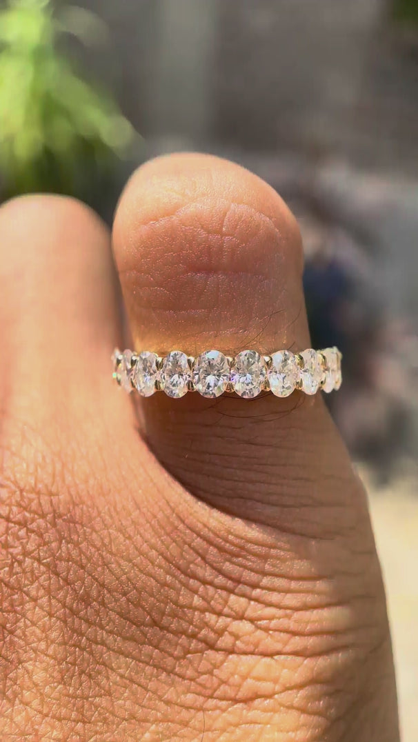 Rotating video of oval moissanite half eternity band showcasing sparkle and design