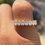 Rotating video of oval moissanite half eternity band showcasing sparkle and design