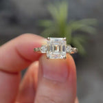 Rotating view of floral cluster ring held between two fingers 