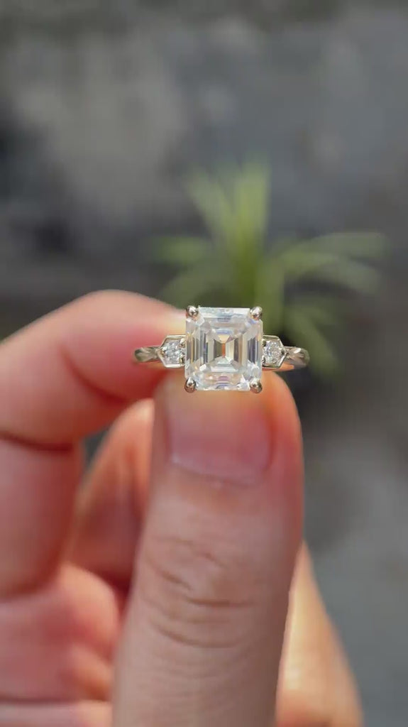Rotating view of floral cluster ring held between two fingers 