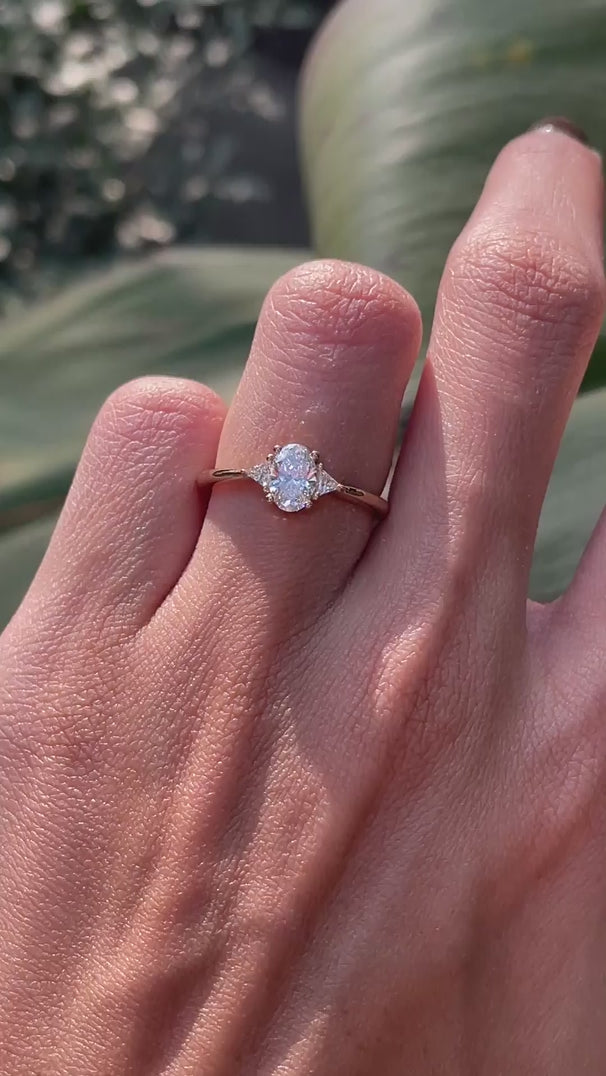 Oval lab diamond three stone ring on hand lifestyle video