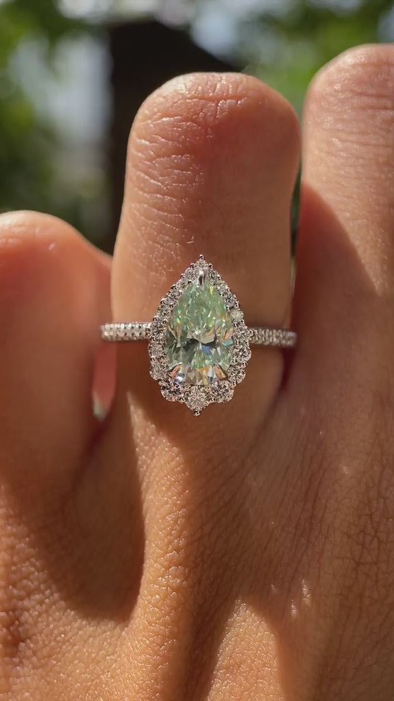Light green pear moissanite halo engagement ring on fingure video