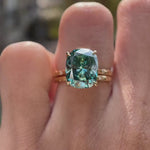 Blue green moissanite starburst engagement ring set with matching celestial band