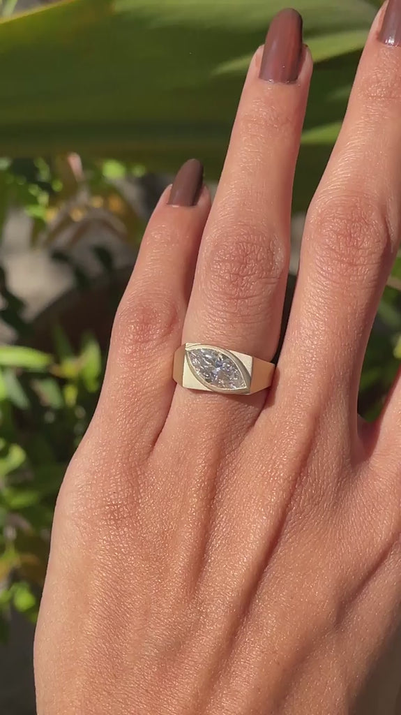 Marquise moissanite signet ring in 10k yellow gold shown in rotating video