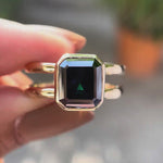 Moissanite Solitaire Elongated Asscher Ring showcasing its unique black green stone with high polish finish