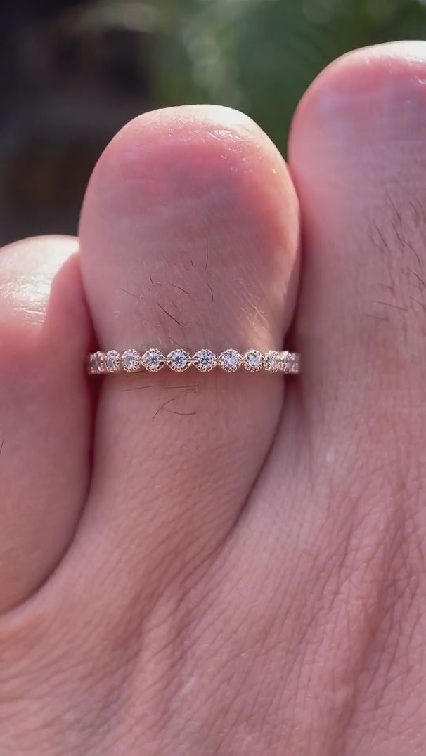 Close up video of half eternity Art Deco bezel set moissanite wedding band
