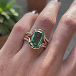 Rotating view of green moissanite floating half bezel ring in yellow gold