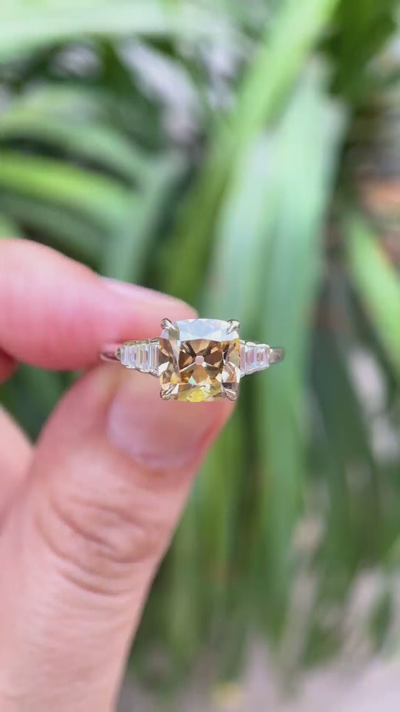 Rotating view of champagne cushion ring with baguette side stones set