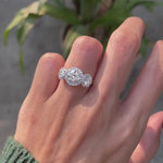 Elegant three stone round halo ring worn on hand video