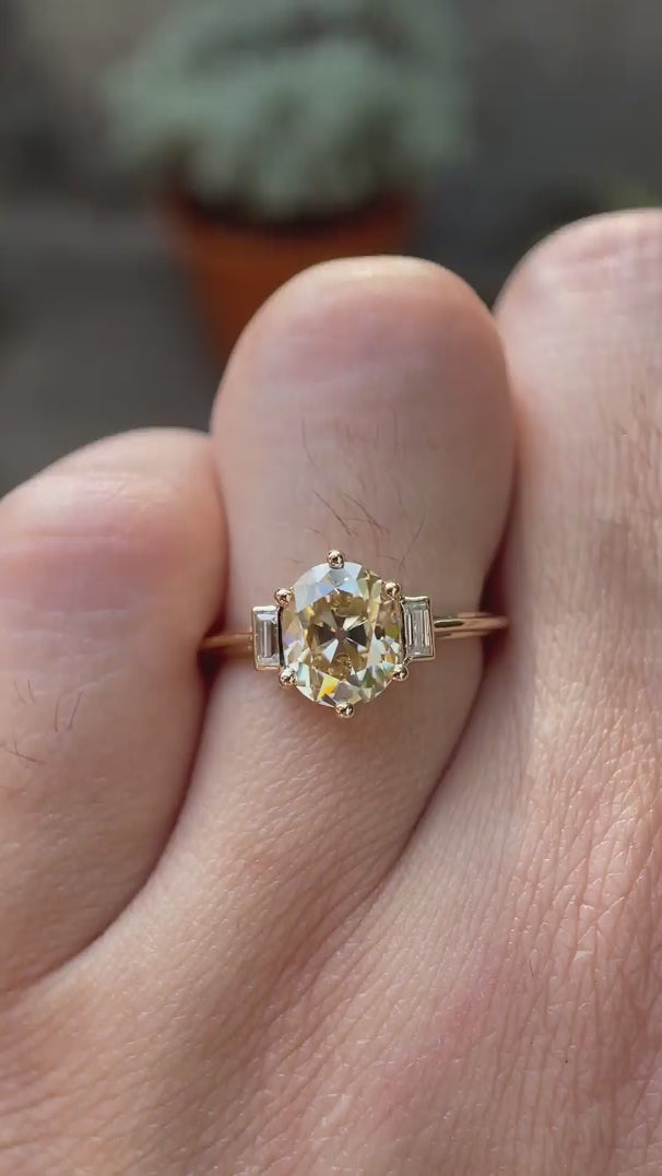 Video showcasing Champagne three-stone ring with baguette accents.