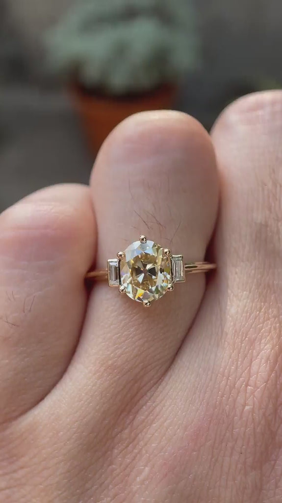 Video showcasing Champagne three-stone ring with baguette accents.