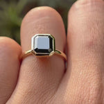 Asscher cut dark green moissanite bezel set solitaire ring rotating view showcasing side profile and brilliance