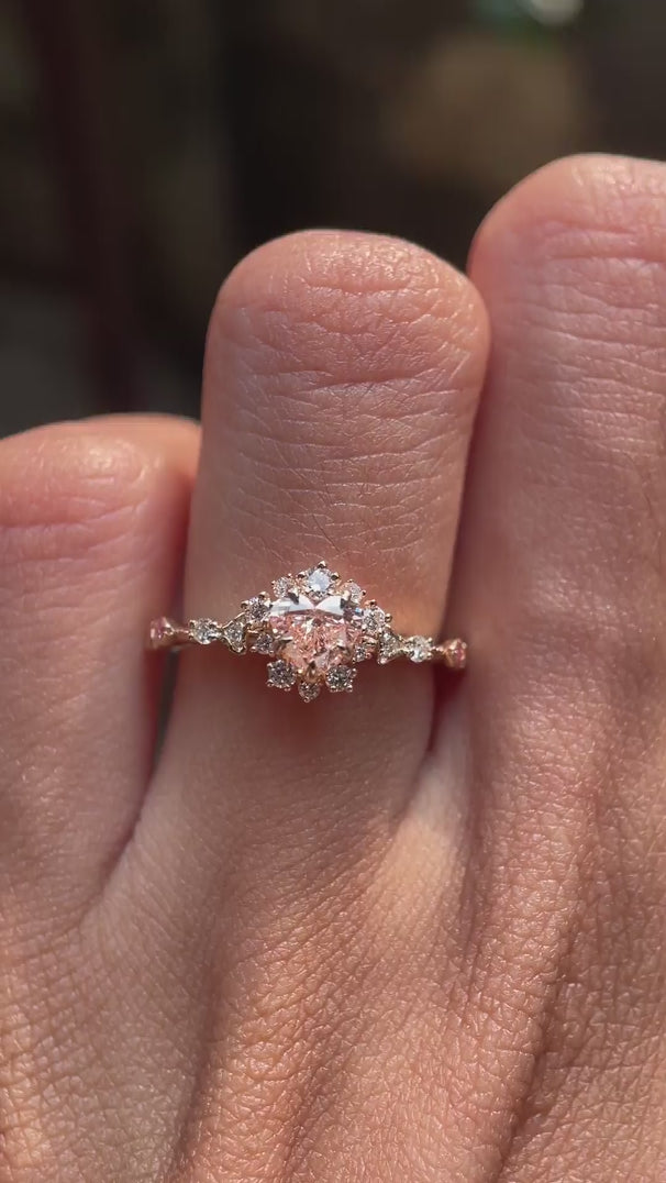 Video showcasing heart shape fancy vivid pink lab grown diamond halo engagement ring in 14K yellow gold