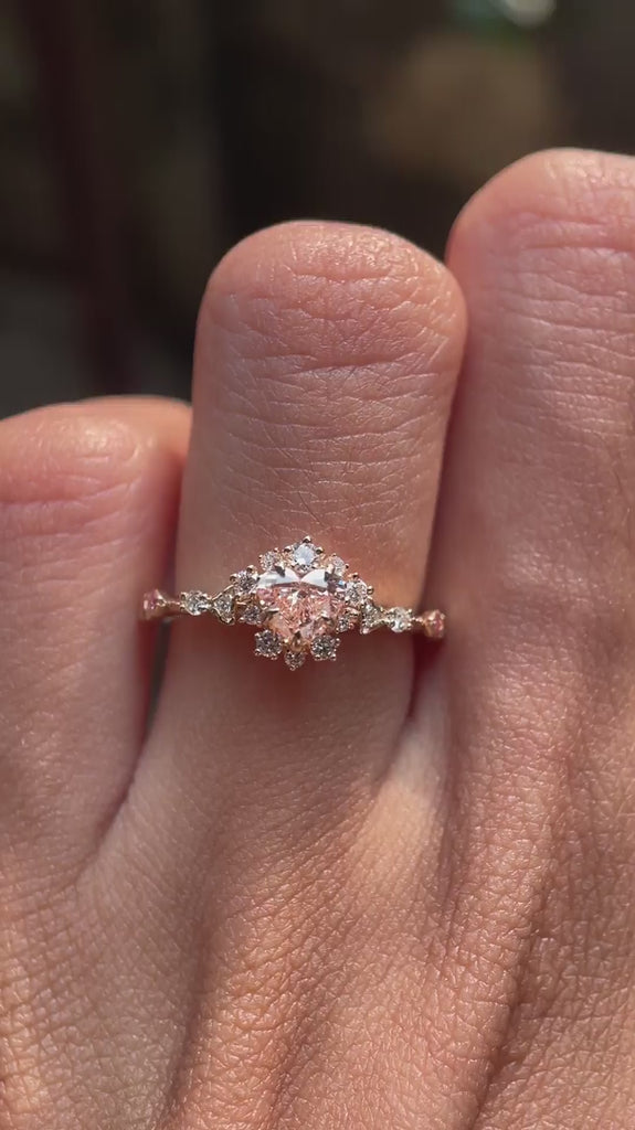 Video showcasing heart shape fancy vivid pink lab grown diamond halo engagement ring in 14K yellow gold
