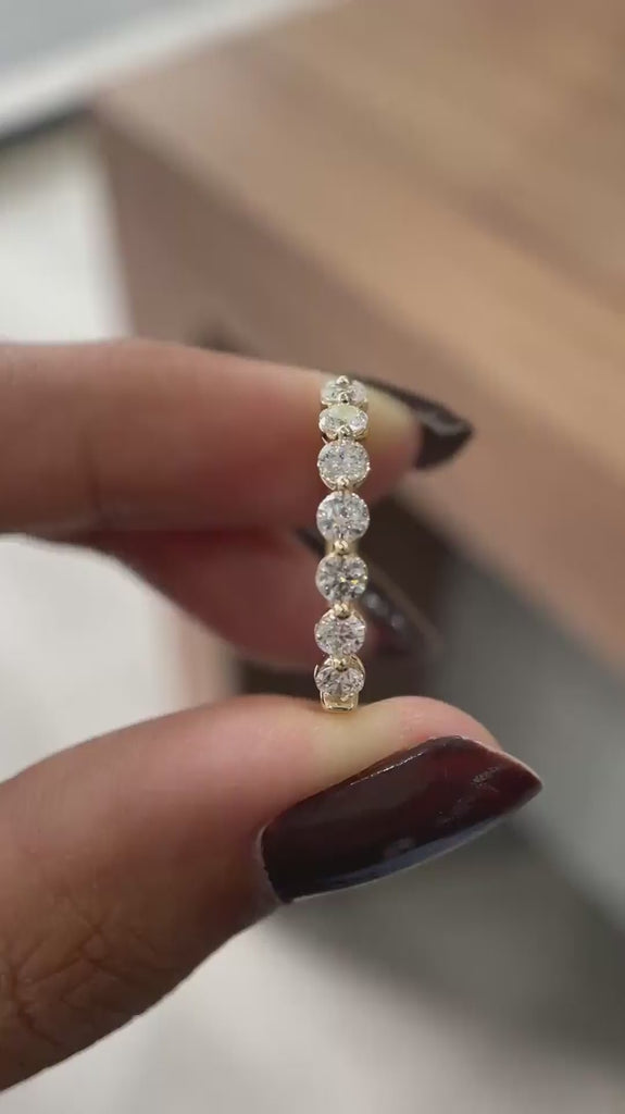 Close rotating view of round lab diamond shared prong half eternity band