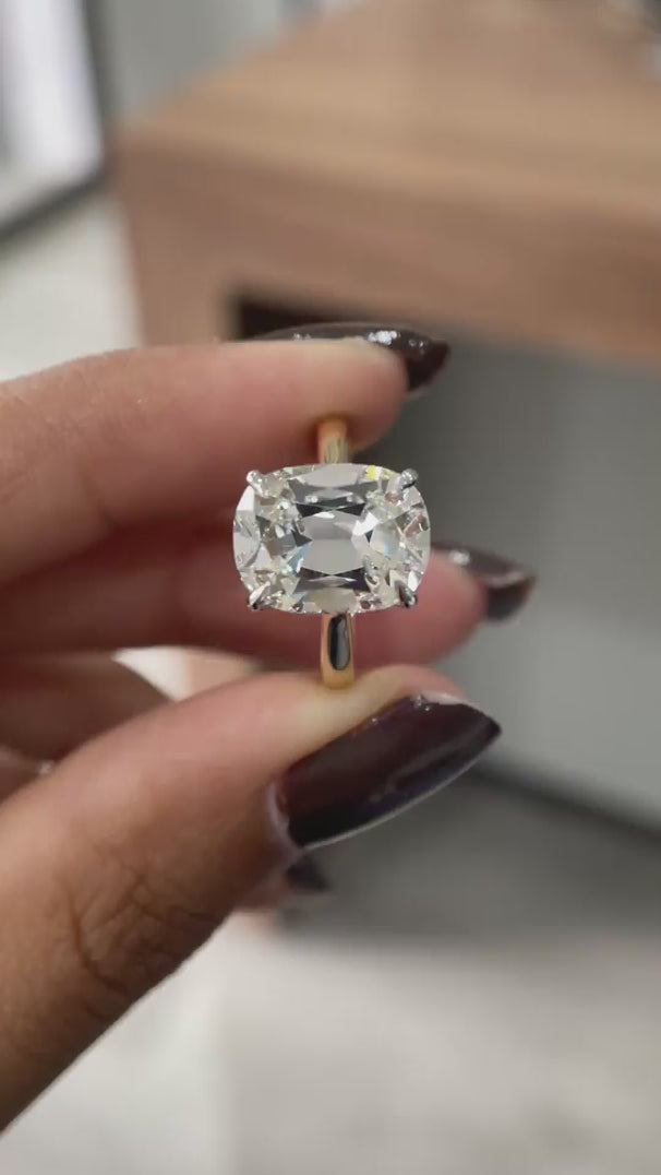 Close rotating view of elongated cushion solitaire ring with hidden halo.