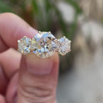 Three stone Old European cut moissanite ring rotating view in yellow gold