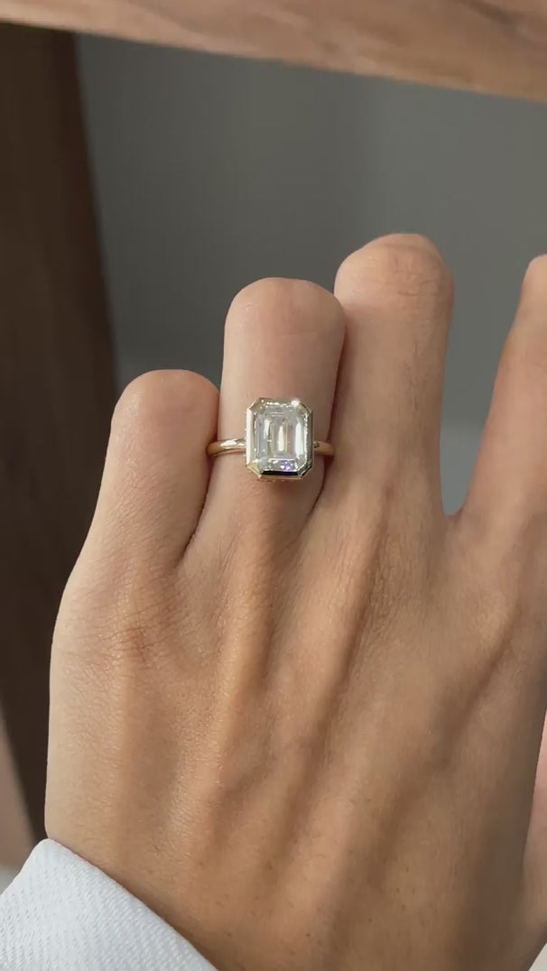 Emerald cut bezel halo engagement ring 18k yellow gold hand video