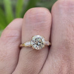 Moissanite three-stone round Old European cut engagement ring with baguette side stones, displayed in a video showcasing the ring from different angles.