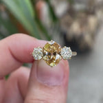 Three stone oval champagne moissanite ring rotating to show details