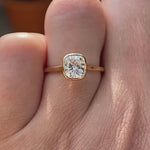 Cushion cut lab grown diamond bezel solitaire ring in 14K yellow gold rotating view