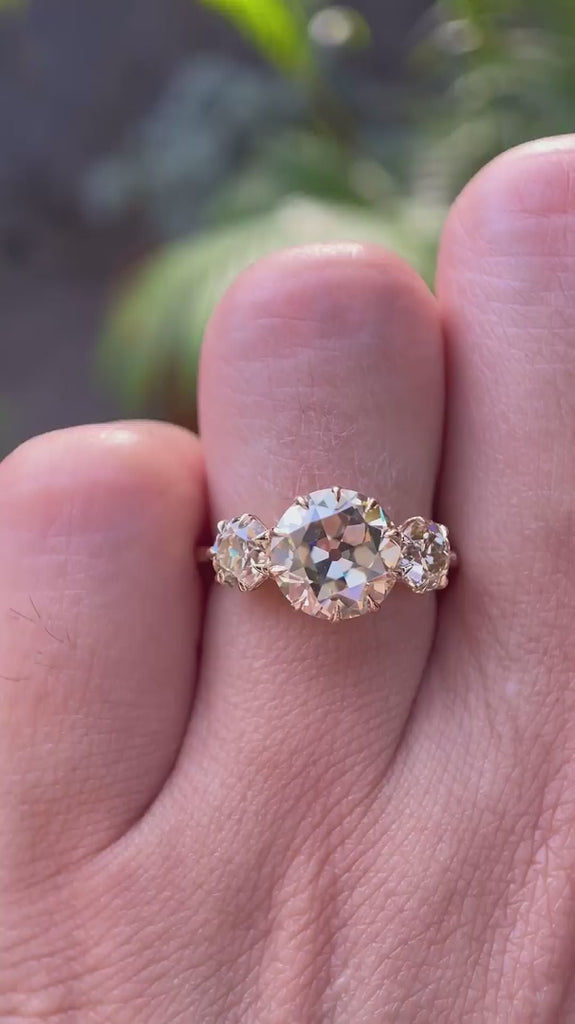 Champagne moissanite three stone engagement ring sparkle and hand view