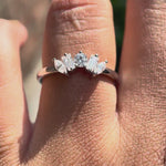 Rotating view of curved multi stone moissanite band in white gold