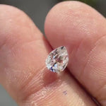 Pear old mine cut white moissanite showing sparkle