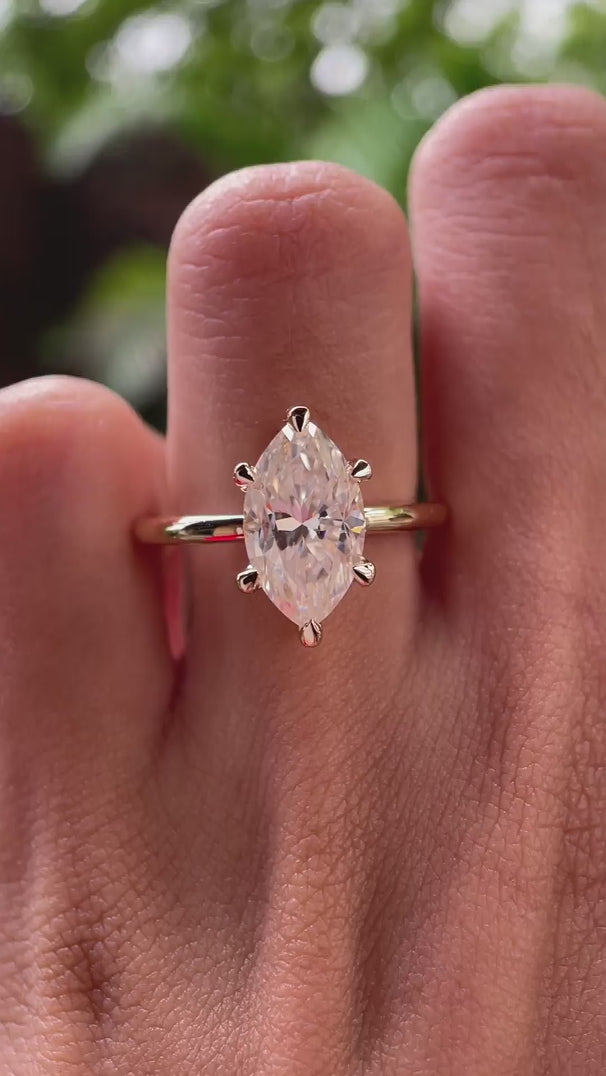 Video showing marquise moissanite solitaire ring sparkle in yellow gold.