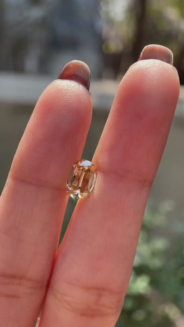Rotating champagne elongated cushion old mine cut loose moissanite video