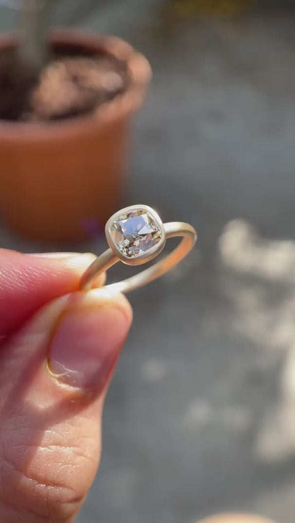 Video showing the Cushion Cut Old Mine Dark Champagne Moissanite Solitaire Bezel Set Engagement Ring
