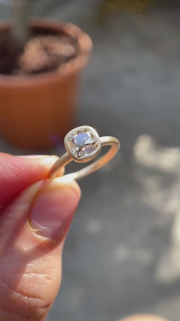 Video showing the Cushion Cut Old Mine Dark Champagne Moissanite Solitaire Bezel Set Engagement Ring