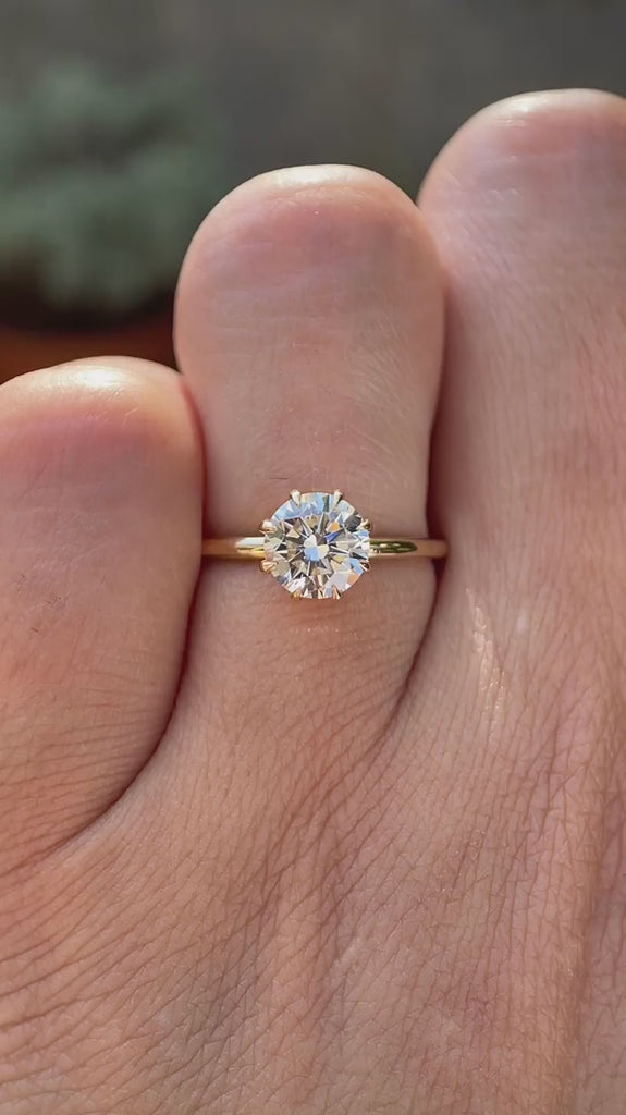 Round brilliant 1 CT lab grown diamond solitaire ring in 14K yellow gold rotating view