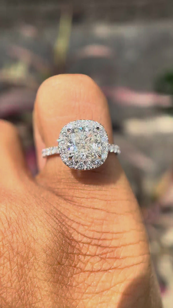 Cushion cut lab grown diamond cluster halo engagement ring in 18K white gold shown from multiple angles, highlighting pavé band and elevated halo setting.