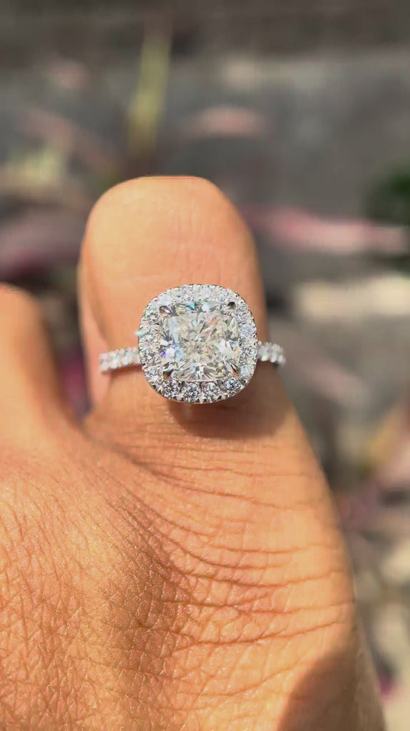 Cushion cut lab grown diamond cluster halo engagement ring in 18K white gold shown from multiple angles, highlighting pavé band and elevated halo setting.