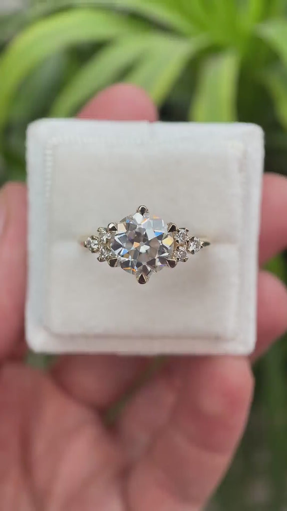 Rotating view of OEC Moissanite cluster engagement ring in yellow gold.