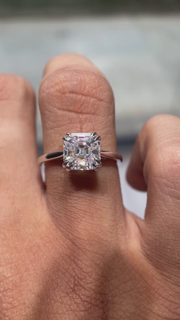 Video of Asscher cut Moissanite solitaire ring rotating in 14K white gold, showcasing its beauty and clarity.